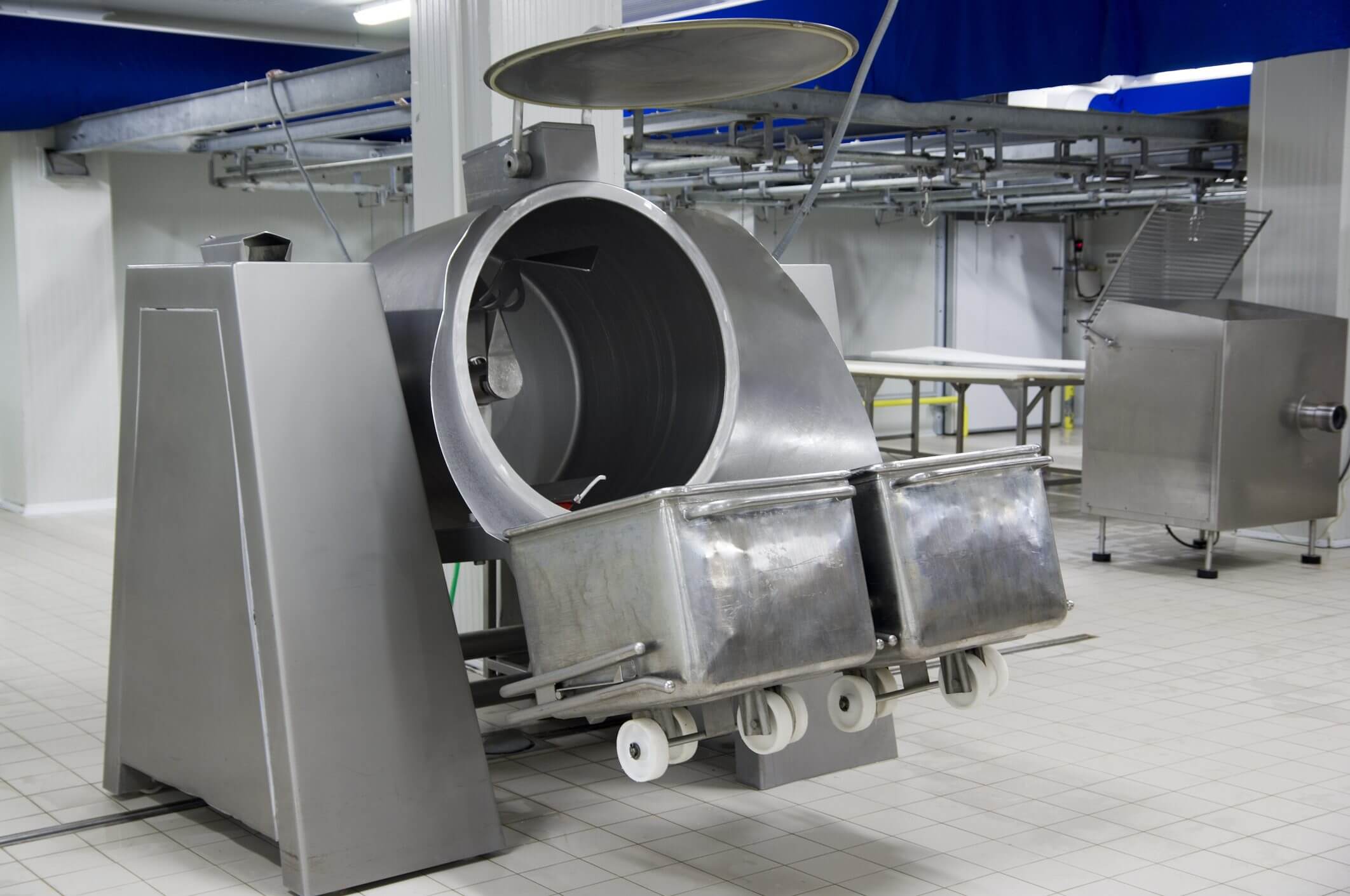 Industrial meat processing machine in a factory.