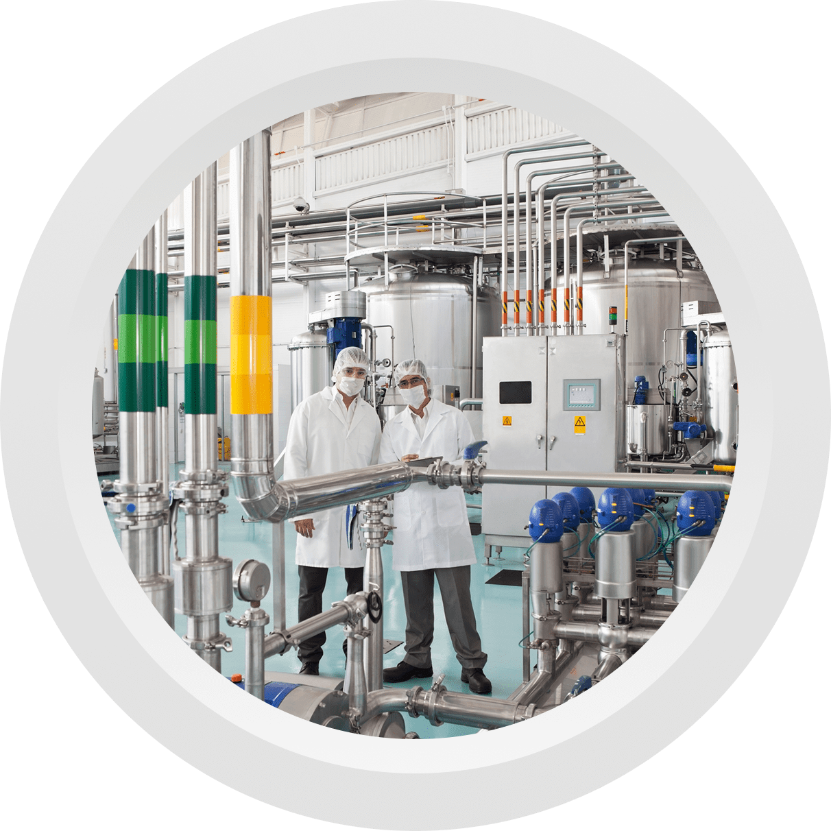 Scientists in a laboratory with industrial equipment.